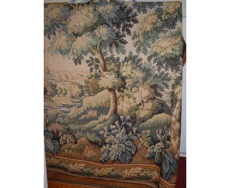 An extremely large Continental tapestry embroidered wall hanging, depicting a Classical river landscape scene within floral d