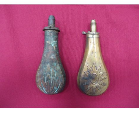 Two Copper Body Powder Flasks consisting copper body with leaf decoration. Brass top with graduated nozzle. Spring absent. Fl