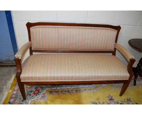 An oak framed open armed sofa with pink and green striped upholstery, approx 153cm wide