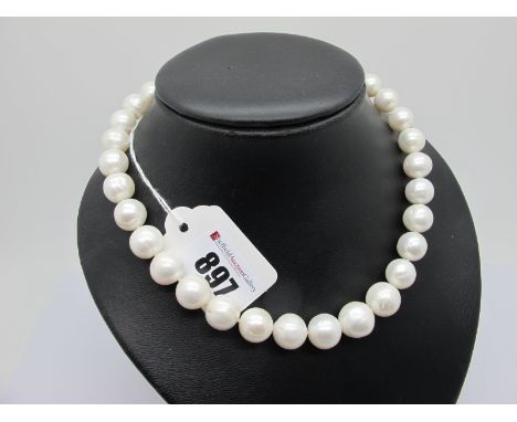 A Large Modern Single Strand Pearl Bead Necklace, the (imperfect) beads to satin finish ball clasp, stamped "375" (overall le