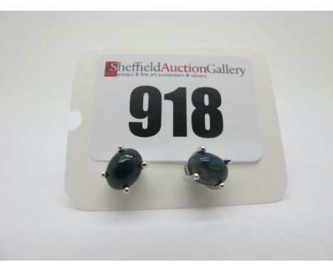 A Pair of Modern Single Stone Black Opal Earstuds, each oval cabochon four claw set, stamped "925".