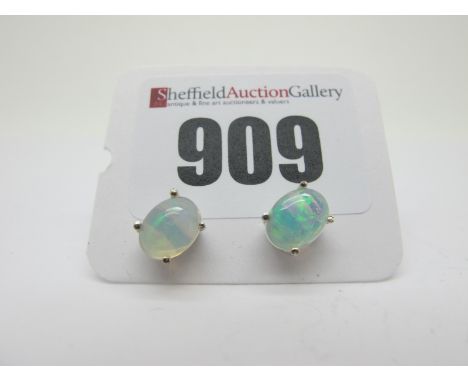 A Pair of Modern Single Stone Opal Earstuds, each oval cabochon four claw set, stamped "925".