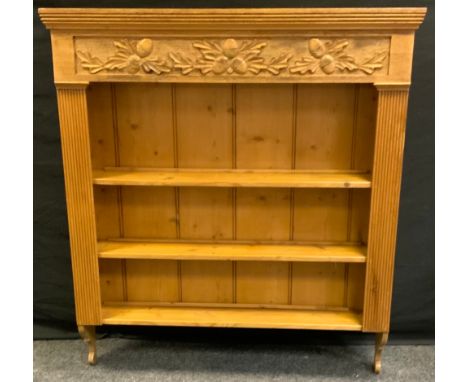 A wall hanging shelf, over sailing top above carved Acorn frieze, three graduated shelves, shaped terminals, 116cm high, 103c