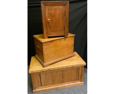A rectangular pine trunk, hinged lid, 48cm x 92cm x 44cm;  another smaller, 42.5c, 62.5cm, 39.5cm;  a bedside cabinet, 51cm x