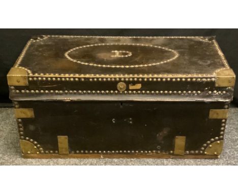 An 18th century brass bound leather travelling trunk, hinged cover, studded borders, swan neck carrying handles, paper label 