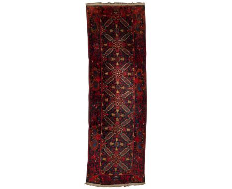 Persian Seikhur Wool Runner  Having an abstract geometric pattern in hues of yellow, blue and black on a red field; having a 