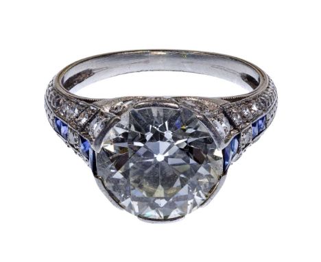 Platinum, Sapphire and 4.37 Carat Diamond Ring  Having a central round cut diamond weighing approximately 4.37 carats (10.48m