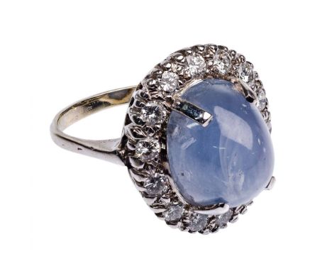 14k White Gold, Pale Blue Star Sapphire and Diamond Ring  Having an oval cut cabochon blue star sapphire weighing approximate