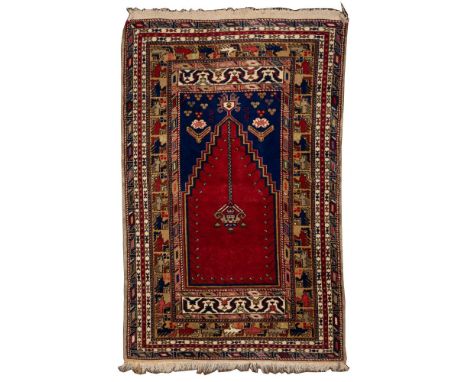 Persian Wool Rug  Hand woven having a mosque pattern in hues of tan, gray, cream, mauve and black on a red field; having frin