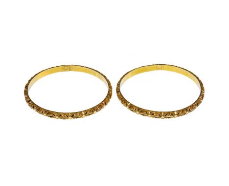 22k Yellow Gold Bangle Bracelets  Pair having floral decoration; foreign markings inside bands  Property from: a Chicago, Ill