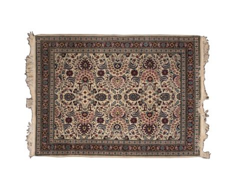Persian Kashan Wool Rug  Having an abstract floral pattern in hues of pink, wine, blue and gold on a cream field; having frin