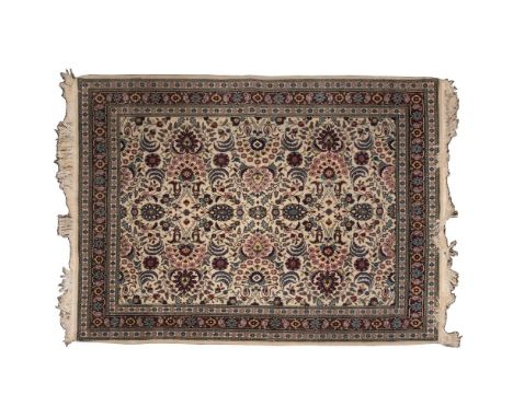 Persian Kashan Wool Rug  Having an abstract floral pattern in hues of pink, wine, blue and gold on a cream field; having frin