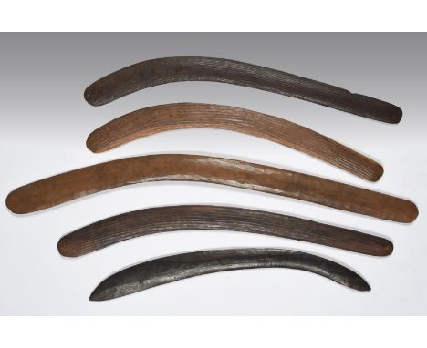 Five Aborigine boomerangs Australia three with wide channelled grooves, 73.5cm and 70cm long, the lighter wood with collectio
