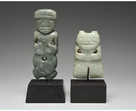 Two Atlantic Watershed pendants Costa Rica, circa 100 - 500 AD jade, one carved a figure with crossed legs, with one hand on 