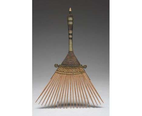 A Bali comb Indonesia with carved decoration and brass wirework binding, 24cm high.