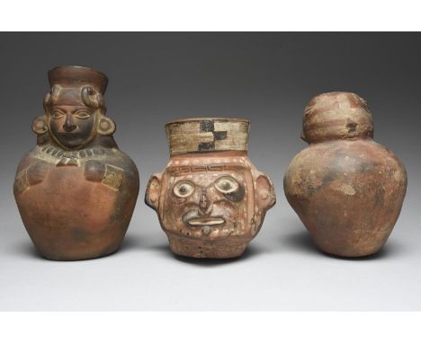 Three Peru vessels including a Moche mask vessel, circa 450 - 550 AD, representing a jaguar transformation, with painted deco