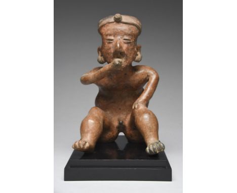 A Nayarit seated male hunchback figure Mexico, circa 100 BC - 250 AD terracotta, wearing a head band and multiple earrings, w