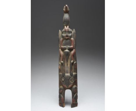 A Northwest Coast model totem Canada relief carved birds, animals and figures, with shell inset eyes and with red and black p