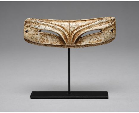 A pair of Inuit snow goggles Arctic bone, of zoomorphic transformation form with a ridged brow and curved eye slits, the side