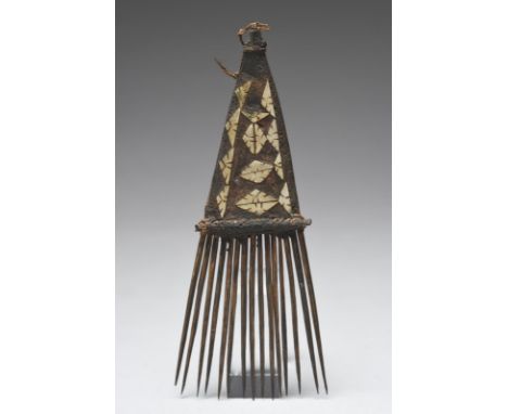 A Solomon Islands comb Melanesia reed, leaf fibre, cut shell and gum, 17.5cm high.