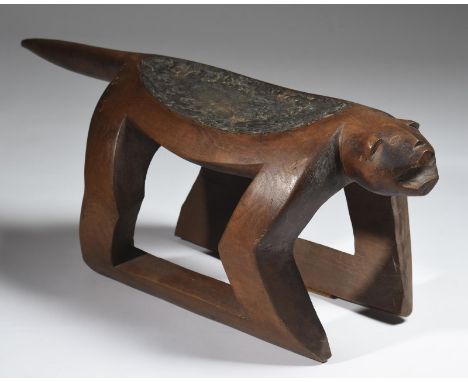 An Amazon zoomorphic priest's stool Ye'Kuana, Venezuela carved as a jaguar, the dished oval top with remains of a resin, 37cm