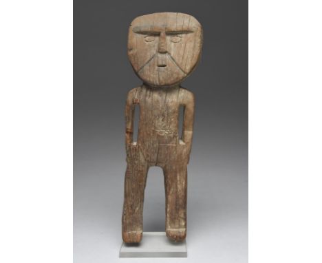 A Huari standing figure Peru, circa 1200 AD with carved and black pigment detailing to the face, with arms to the side and wi