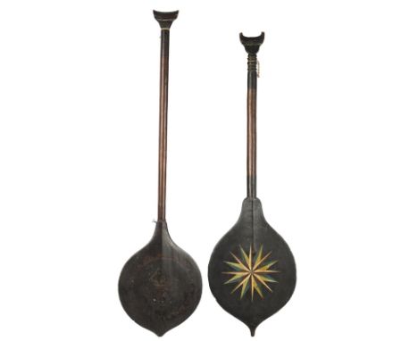 Two Suriname paddles South America one with painted a star and sun motif to each side of the blade, the other with shallow ca