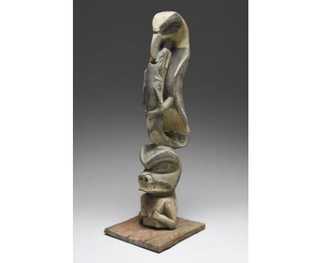 A model Totem pole Northwest Coast of North America with a bear holding a copper, with a whale in the beak of an eagle, with 