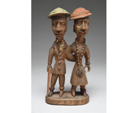 Thomas Ona. A Yoruba standing couple Nigeria both wearing hats and formal clothing with stipple decoration, the man with a ca
