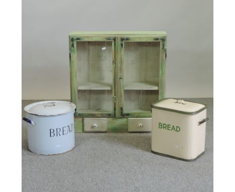 An enamel bin, together with another and a hanging cabinet, 67cm