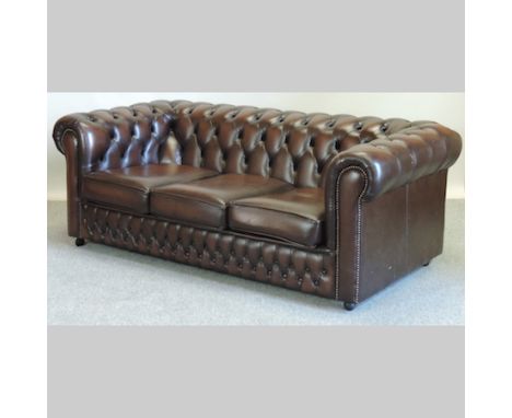 A modern brown leather upholstered three seater Chesterfield sofa, 173cm