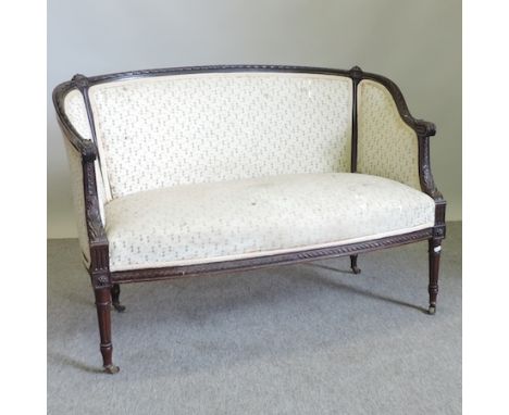 An Edwardian cream upholstered bergere sofa, on turned legs and castors, 111cm