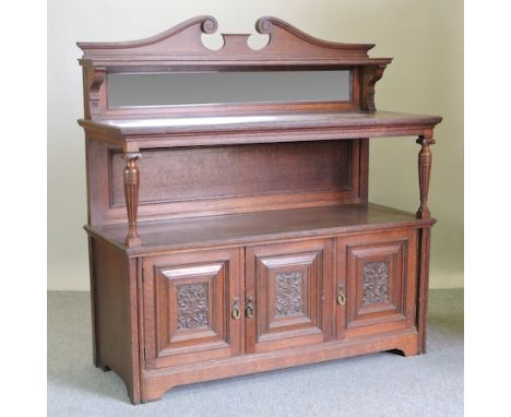 A Victorian carved oak buffet, with a mirrored back, 152cm