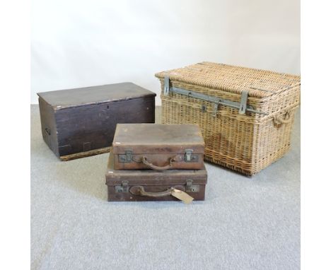 A large wicker hamper, 84cm, together with a black painted trunk and two suitcases