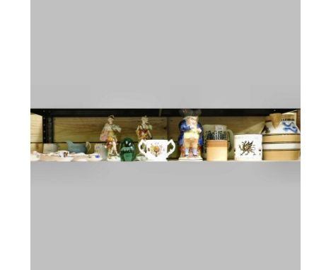 A shelf of china to include a Mocha ware jug, 18cm tall, a Wedgwood Guyatt commemorative mug, a toby jug, continental figures