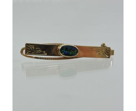 A 9 carat gold tie clip, set with an opal