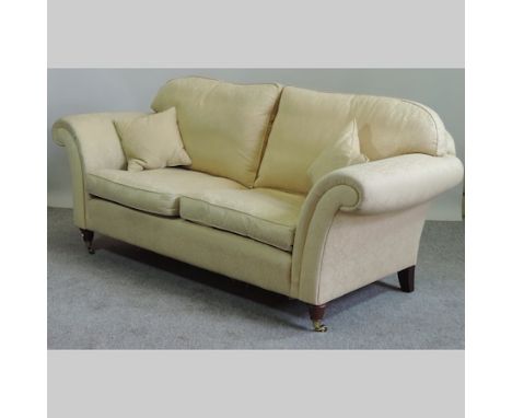 A Laura Ashley yellow upholstered sofa, on turned legs, 195cm