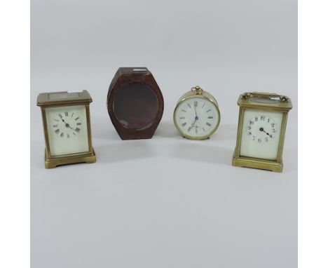 An early 20th century brass cased drum clock, 10cm tall overall, cased, together with a brass carriage clock, and another, 15