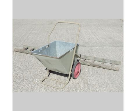 A green painted galvanised garden barrow, 75cm overall, together with a wooden ladder