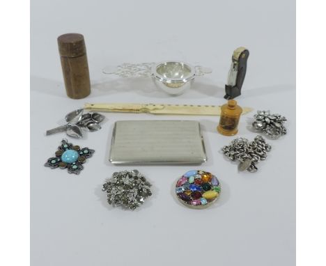 A collection of items to include a novelty lighter in the form of a penguin, costume jewellery brooches and a watch chain