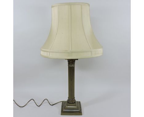 An early 20th century brass corinthian column table lamp, with a cream silk shade, 74cm tall overall