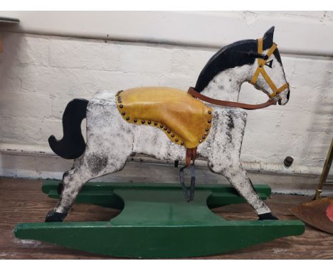 A dabble grey rocking on horse with leather saddle on a green rocking base. 80cm x 95cm x 28cm. 