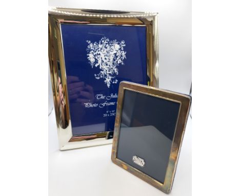 A silver frame 15cm x 11cm, hallmarked R Carr's Sheffield, 1994 weighing 196gms,  and a silver plate frame 20cm x 25cm, 586gm