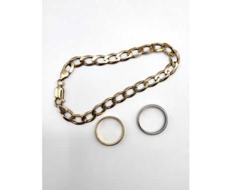 A fully hallmarked platinum ring, size K1/2, 3.9gms, a gold wedding band with faint scroll work inscribed 7 1964, size K, 1.2