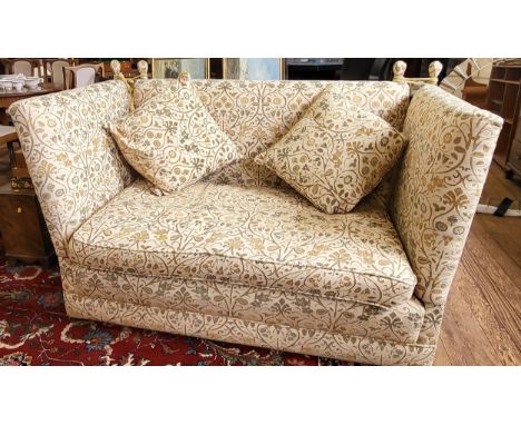 A vintage two seater Knole sofa in cream upholstery, with two matching cushions and on casters. H 100cm W 160cm D 90cm. 