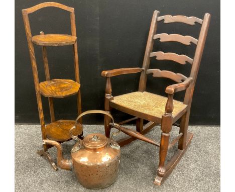 An Edwardian folding three tier cake stand,  a small size Childs ladder back Rocking chair;  large 19th century copper kettle