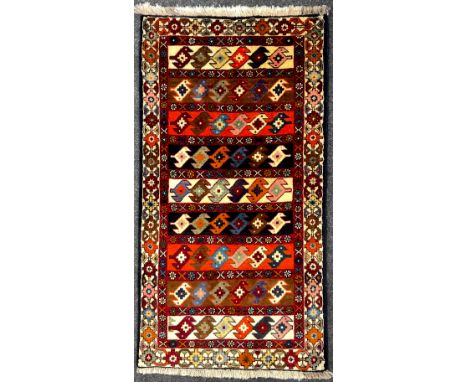 A North-west Persian Yallemeh rug / carpet, hand-knotted in rich tones of red, blue, orange, and deep indigo, 155cm x 85cm. 