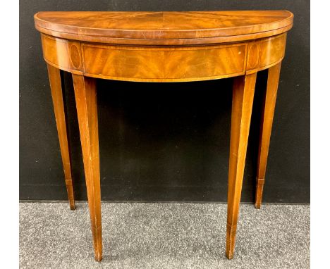 A 19th century style reproduction mahogany card-table, cross-banded Demi-lune shaped top, tapered square legs, 78.5cm high x 