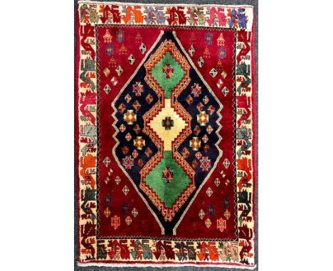 A South-west Persian Qashgai rug / carpet, hand-knotted with a triple medallion, within a field of stylised motifs, in rich t