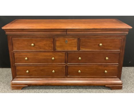 A Willis and Gambier ‘Antoinette’ model (or similar) sideboard / large chest of drawers, the rounded rectangular top with pai